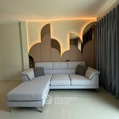 Modern living room with stylish sofa and unique wall design, perfect for contemporary homes.
