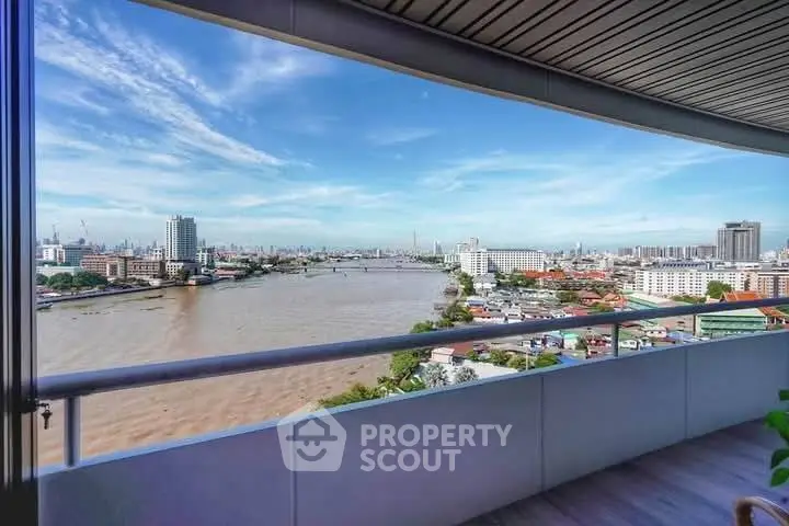 Stunning river view from a high-rise balcony in a modern cityscape.