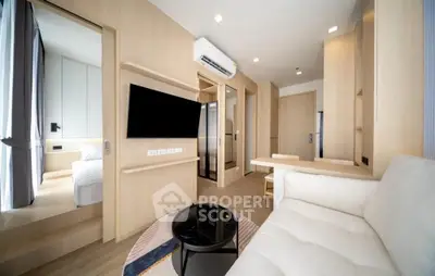 Modern living room with sleek design, featuring a cozy sofa, wall-mounted TV, and stylish decor.