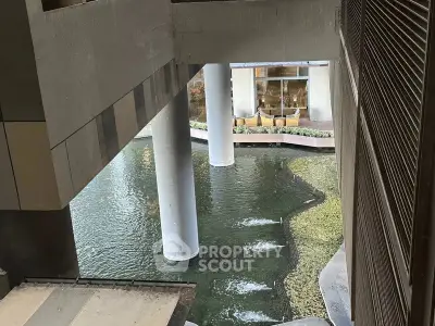 Modern architectural building with unique water feature and columns