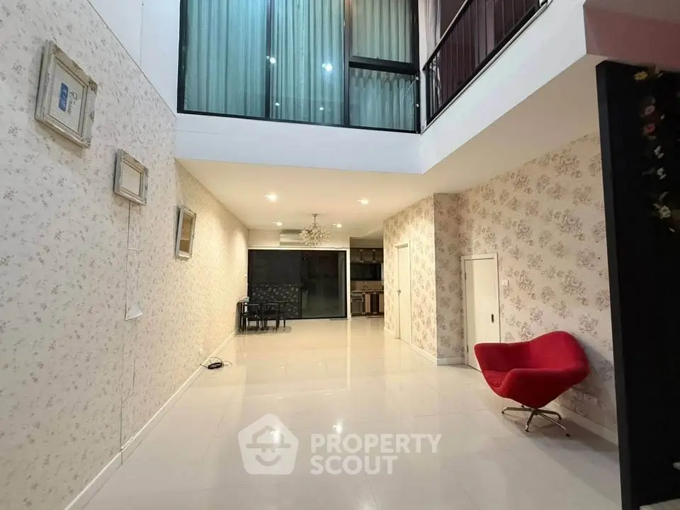Spacious modern living area with high ceilings and elegant decor