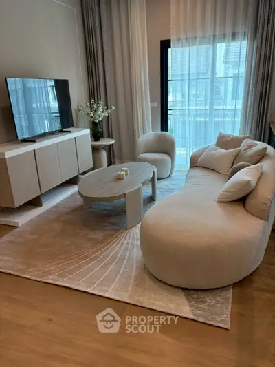 Elegant modern living room with stylish furniture and large window view.