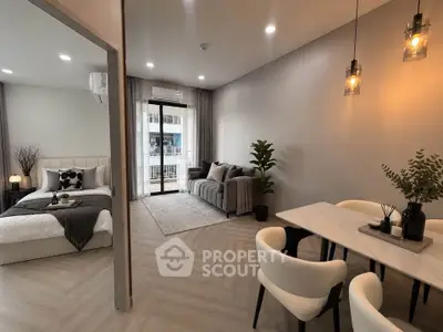 Modern open-plan living room and bedroom with stylish decor and natural light.
