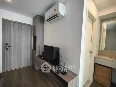 Modern living room with sleek furniture and air conditioning unit, perfect for urban living.