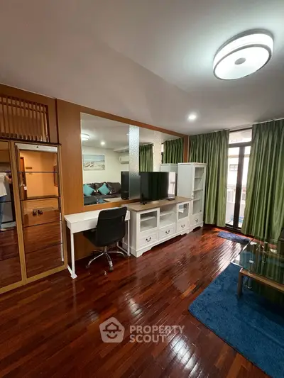 Spacious living room with modern decor and wooden flooring