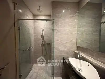 Modern bathroom with glass shower enclosure and sleek sink design