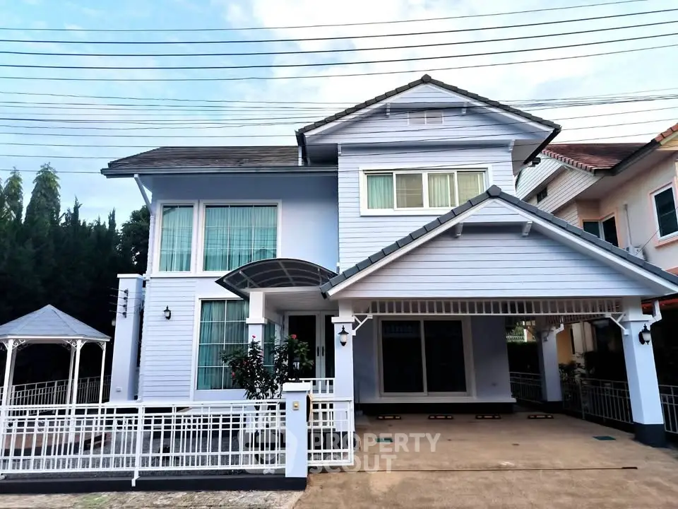Charming two-story house with modern design and spacious driveway in a serene neighborhood.