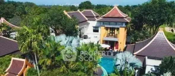 Luxurious tropical villa with pool and lush greenery, perfect for serene living.