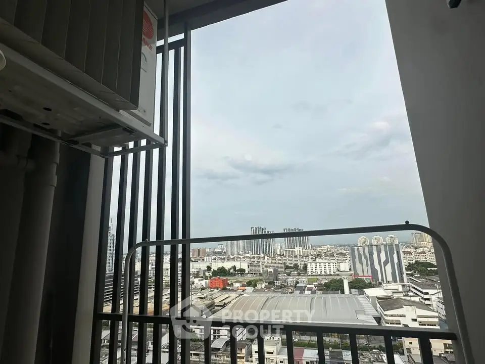 Stunning cityscape view from a high-rise balcony, showcasing urban skyline and expansive horizon.