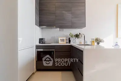 Modern kitchen with sleek dark wood cabinets and built-in appliances