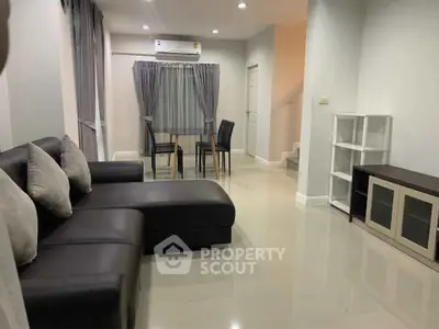 Modern living room with sleek furniture and dining area, perfect for contemporary living.