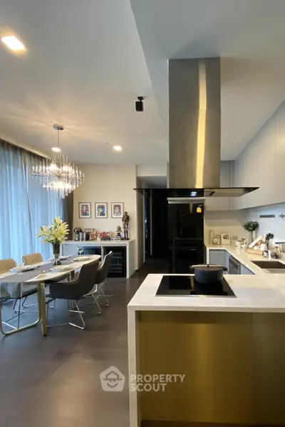 Luxurious modern kitchen with open layout and elegant dining area, featuring sleek appliances and stylish decor.