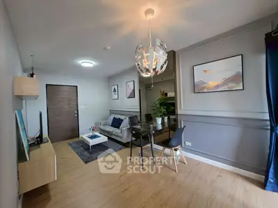 Modern living room with stylish decor and open layout, featuring a cozy seating area and elegant lighting.