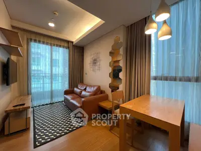Modern living room with leather sofa, wooden dining table, and stylish lighting in a cozy apartment.