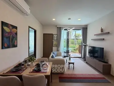 Modern living room with stylish decor and garden view, perfect for relaxation and entertainment.