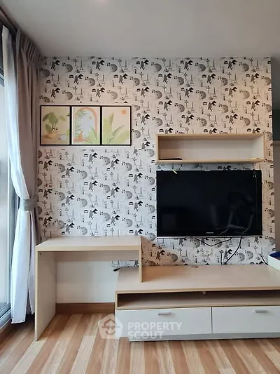 Modern living room with stylish wallpaper and mounted TV for cozy entertainment.