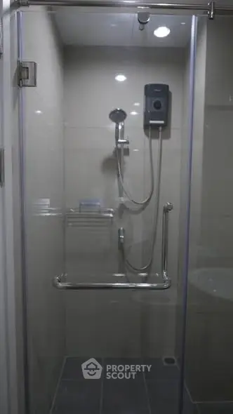 Modern bathroom with glass shower enclosure and sleek fixtures