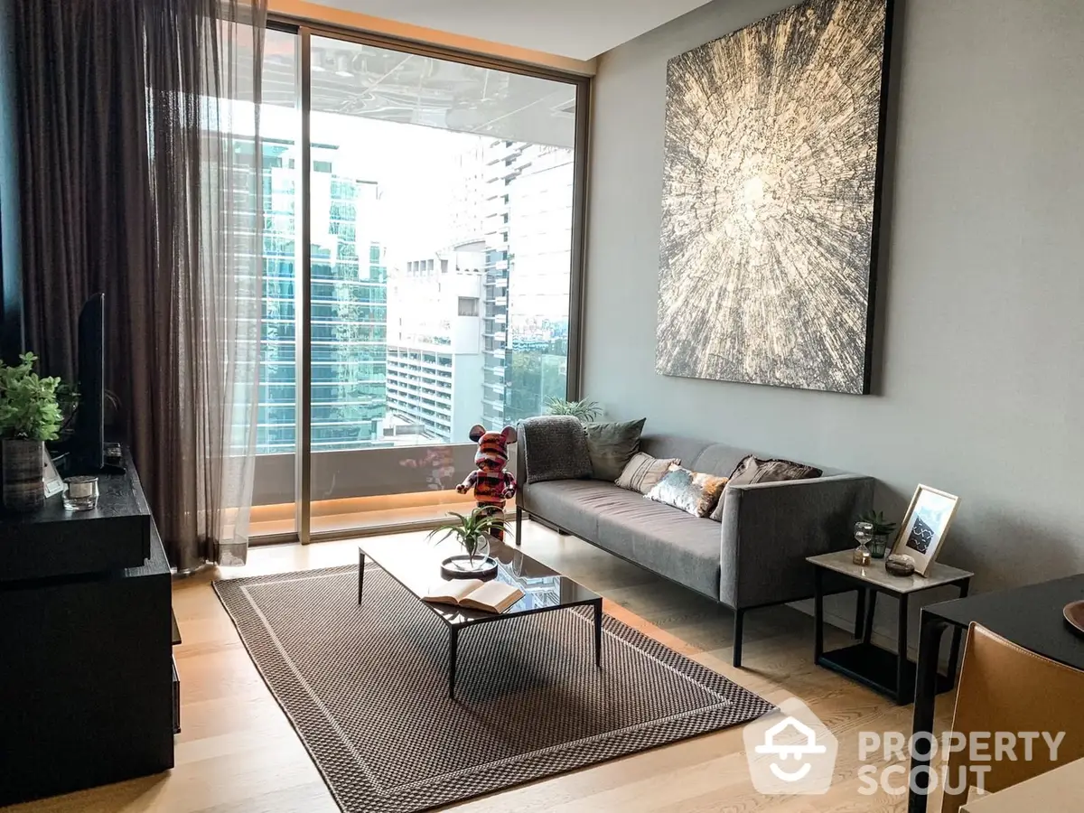 Modern living room with floor-to-ceiling windows offering an urban view, complemented by sleek furnishings and tasteful decor.