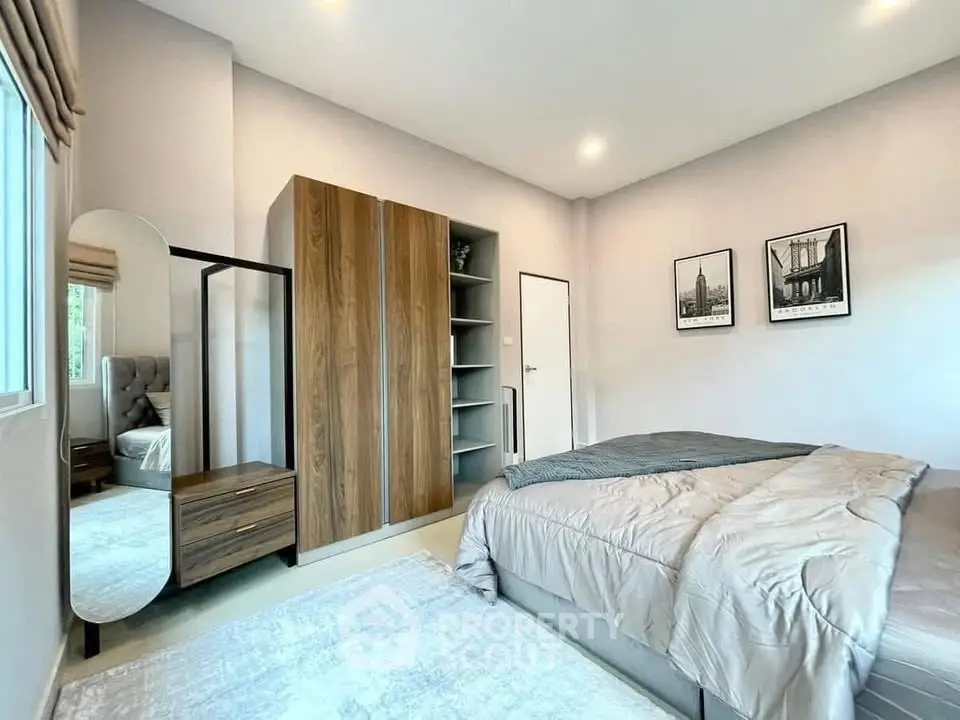 Modern bedroom with stylish decor and ample natural light