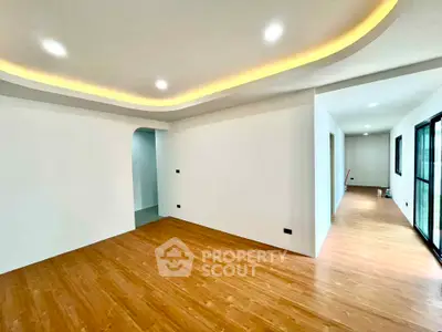 Spacious modern living room with wooden flooring and recessed lighting