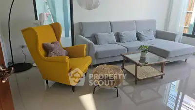 Modern living room with stylish yellow armchair and gray sofa