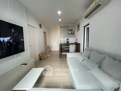 Modern living room with cozy gray sofa and wall-mounted TV