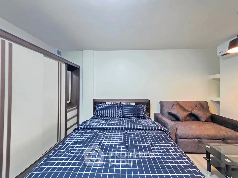 Modern bedroom with stylish decor and cozy seating area, perfect for relaxation and comfort.