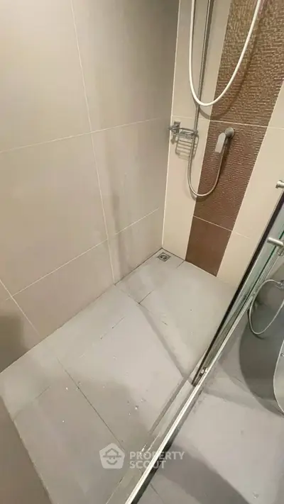 Modern bathroom shower area with sleek tiles and contemporary fixtures.