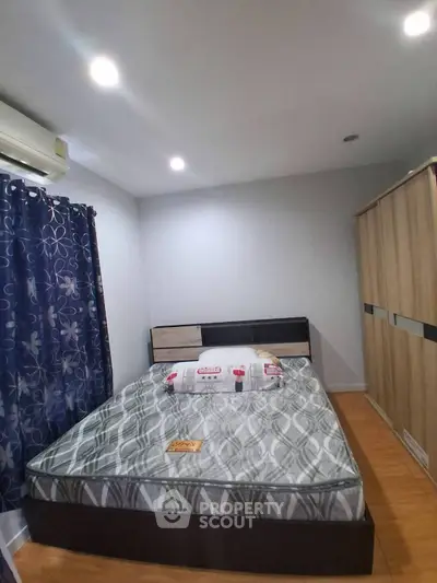 Cozy bedroom with modern decor, featuring a comfortable bed and stylish wardrobe.