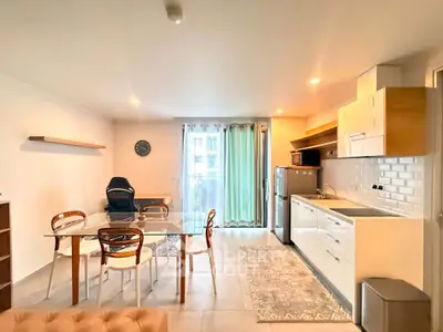 Modern open-plan kitchen and dining area with stylish decor and natural light.