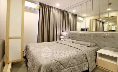 Modern bedroom with mirrored wall and elegant gray decor