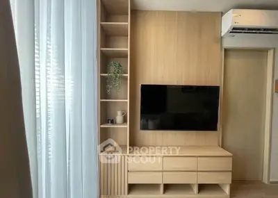 Modern living room with sleek wooden TV unit and air conditioning