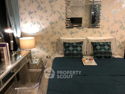 Chic bedroom with elegant decor, mirrored furniture, and stylish bedding, perfect for modern living.