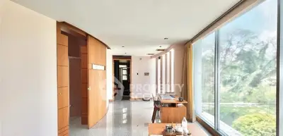 Spacious modern living area with large windows and natural light.