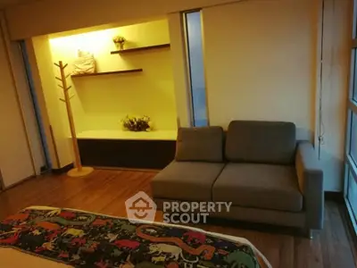 Cozy living room with modern sofa and decorative shelves, perfect for relaxation and style.