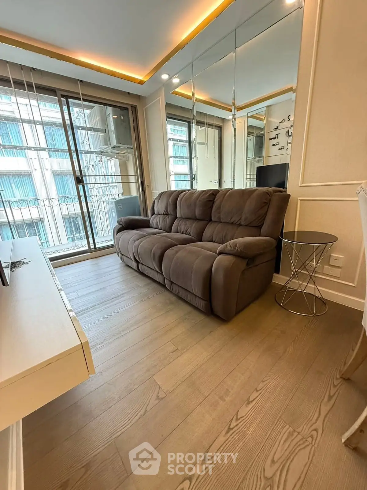 Modern living room with mirrored wall and cozy sofa in urban apartment