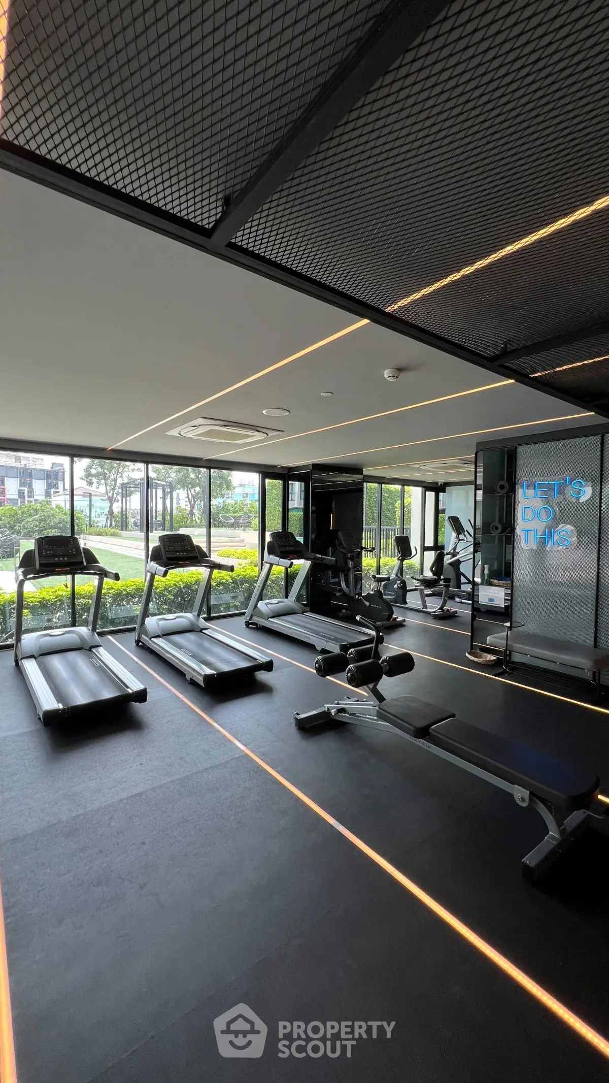 Modern gym with state-of-the-art equipment and panoramic garden views.