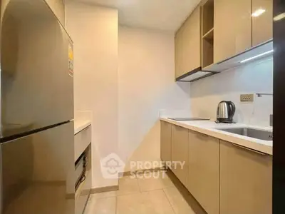 Modern kitchen with sleek cabinetry and stainless steel appliances in a compact layout.