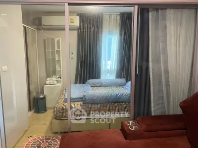 Cozy bedroom with glass partition and modern furnishings in a stylish apartment.