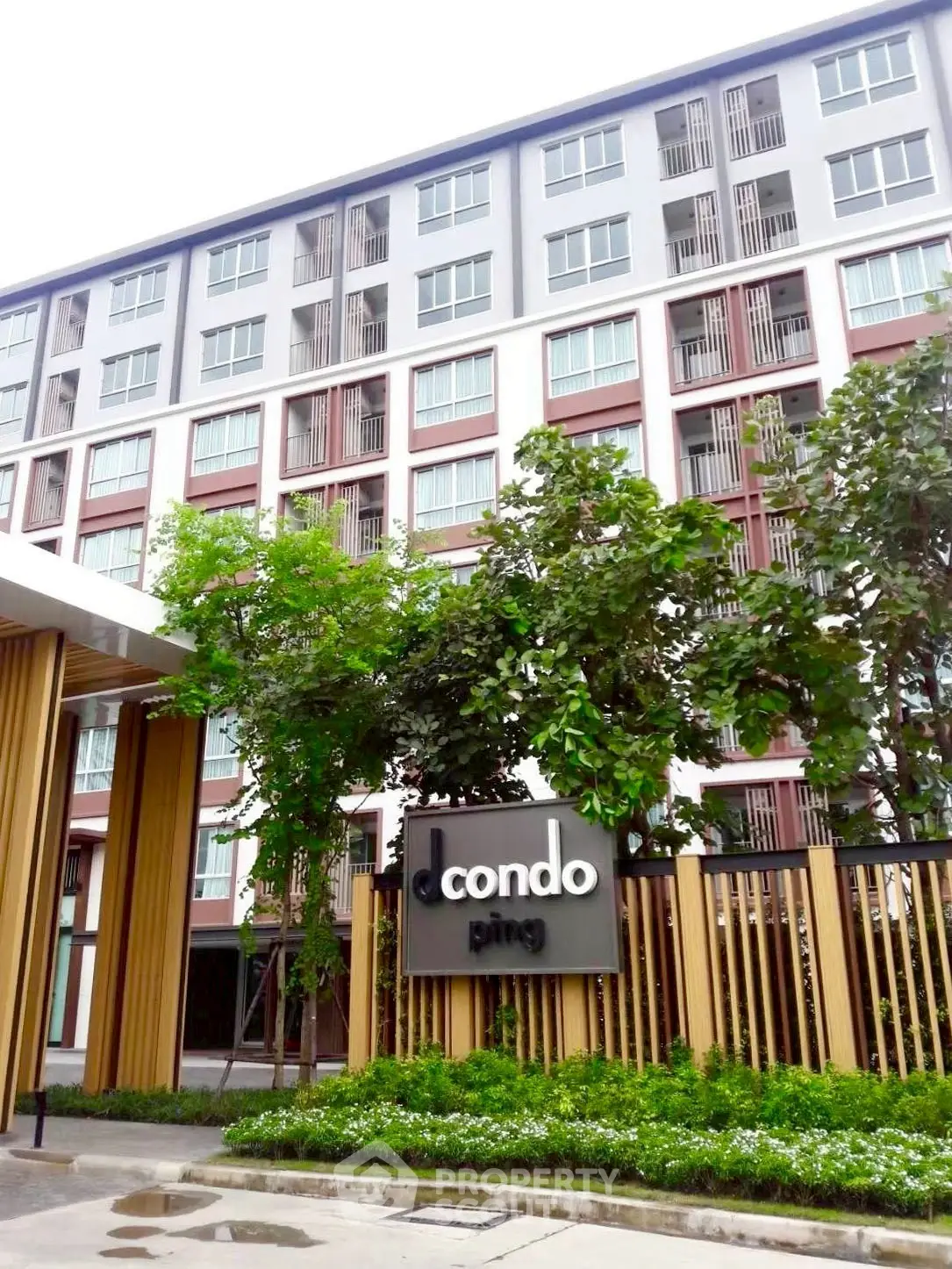 Modern condominium building with lush greenery and stylish facade