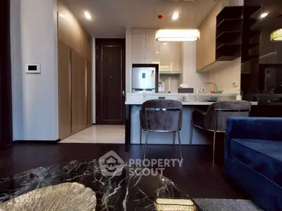 Modern kitchen with sleek design, marble table, and stylish seating in a contemporary apartment.