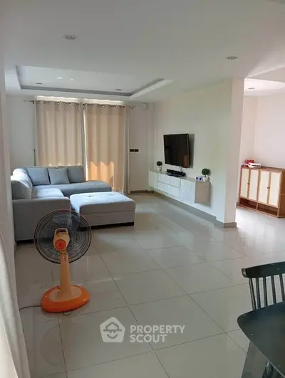 Spacious modern living room with sleek furniture and natural light