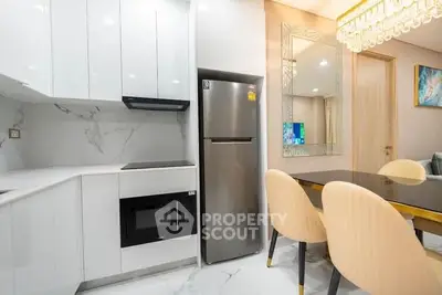 Modern kitchen with sleek appliances and elegant dining area