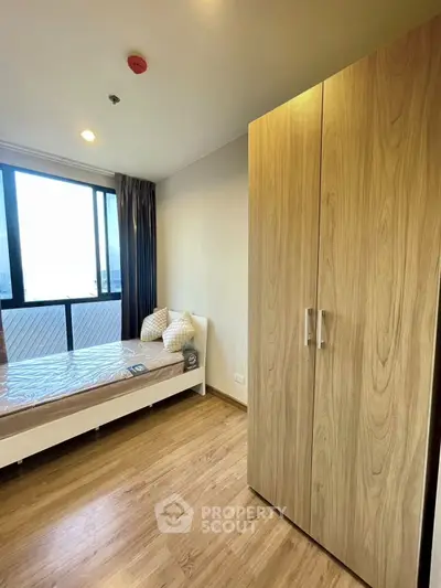 Modern bedroom with large window and stylish decor