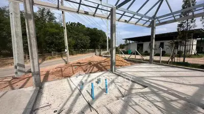 Modern construction site with steel frame structure and open landscape view