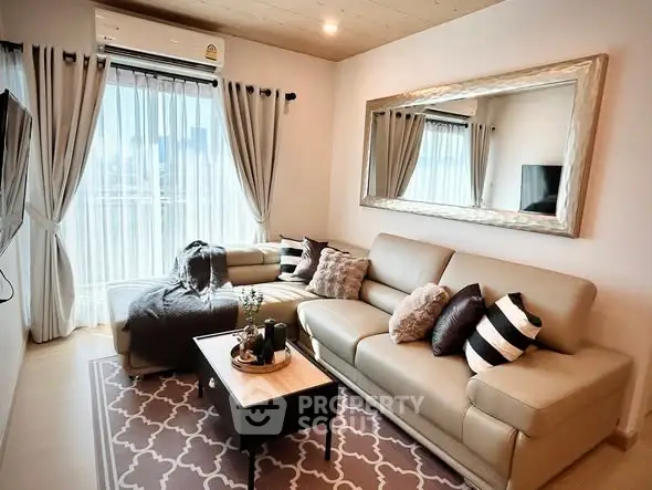 Stylish living room with large mirror and cozy seating in modern apartment