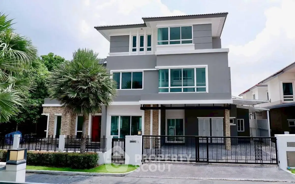 Modern three-story house with sleek design and spacious driveway