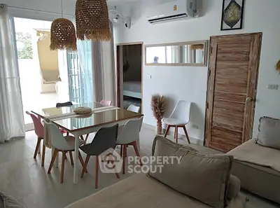 Charming living room with rustic decor and natural light, featuring a cozy dining area and modern furnishings.