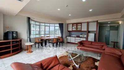 Spacious living room with modern furniture and large windows offering natural light.