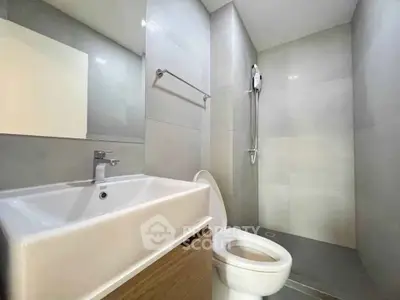 Modern bathroom with sleek fixtures and minimalist design in a contemporary apartment.
